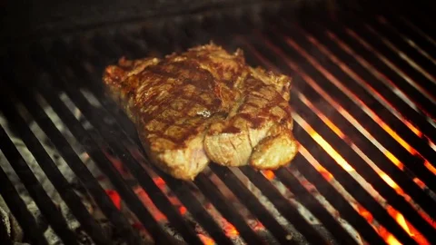 Cooking, juicy steak fried on an open fire on the grill Stock Footage 74306334