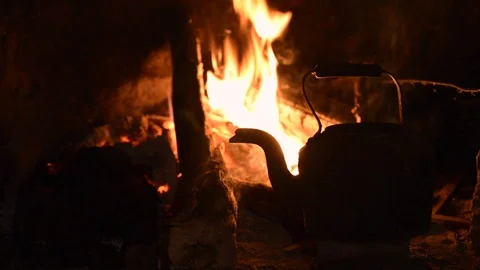 Cooking kettle in fire place on winter night Stock Footage 78645406