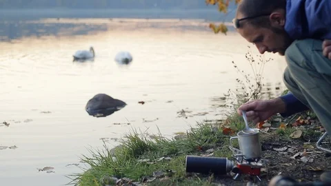 Cooking by the lake Stock Footage 99887668