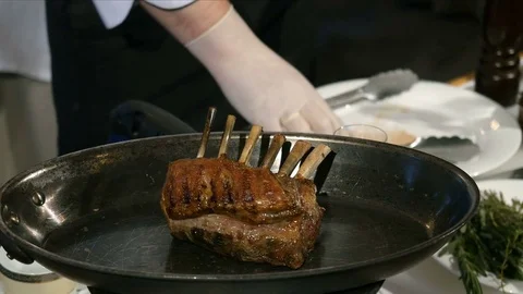Cooking a lamb meat on fire. Chef preparing meat Stock-Footage 85421104