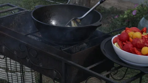 Cooking Lecho on an open fire. Steaming vegetables on the grill. Stock Footage 237607769