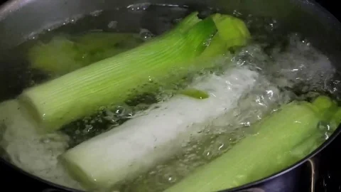 Cooking leeks in a metal pot Stock Footage 74176680