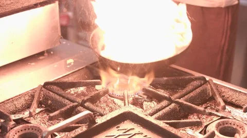 Cooking little bits of meat in pan with fire Stockbeeldmateriaal 72322695