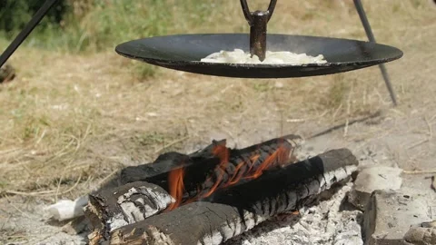Cooking lunch on a campfire during a hike Stock Footage 144682775