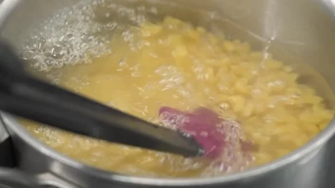 Cooking Macaroni in Boiling Water in a Pot, Close-up Stock Footage 331633625