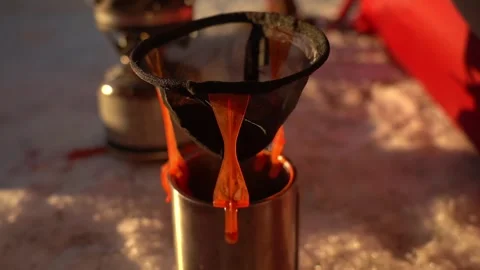 Cooking, making camping coffee  with a simple filter outdoors Stock Footage 313669713