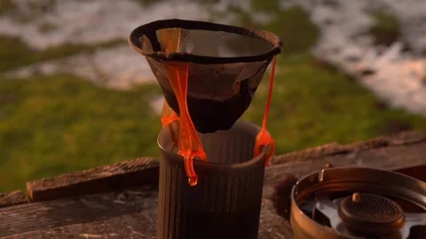 Cooking, making camping coffee  with a simple filter outdoors Stock Footage 313669714