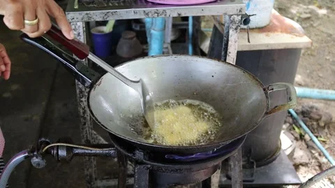 Cooking, making fried bean curd with metal spatula in metal pan and hot oil. Stock Footage 141306327