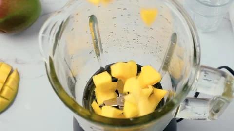 Cooking mango smoothie or milkshake in blender Stock Footage 226126655