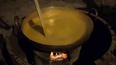 Cooking Mango Soup Paste in Old Way Stock Footage 122431351