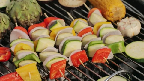 Cooking many various of vegetables on grill close-up. Fry artichoke, corn, red Stock Footage 270544224