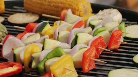Cooking many various of vegetables on grill close-up. Fry artichoke, corn, red Stock Footage 284038245