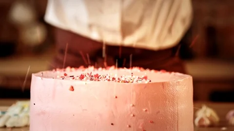 Cooking master class cake decor beads falling pink Stock Footage 112220934