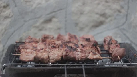 Cooking meat on a grill. Stock Footage 83998885