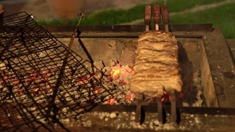 Cooking meat on the grill at night Stock Footage 154887204