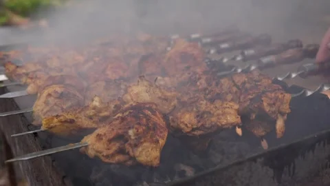 Cooking meat on the grill with open fire. Stock Footage 310765975