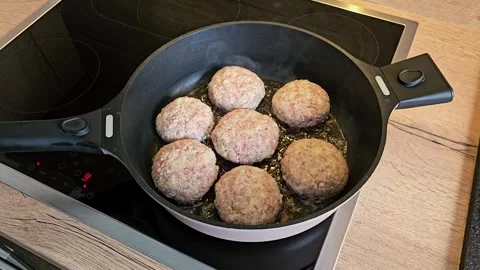 Cooking Meat Patties in a Pan on Electric Stove Stock Footage 305750433