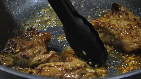 Cooking meat with soy sauce. someone cooks meat in a frying pan Stock Footage 334268396