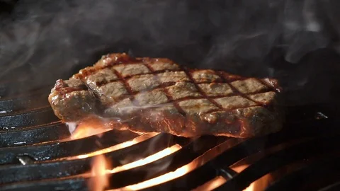 Cooking meat steak on the grill on fire Stock Footage 101799551