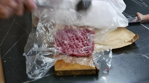 Cooking meat steaks in the kitchen of a cafe, beating meat Stock Footage 304999695