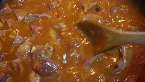 Cooking meat stew with tomato close-up, pork snout Stock Footage 141727733