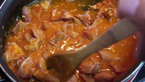 Cooking meat stew with tomato close-up, pork snout Stock Footage 141729954