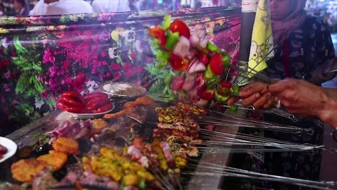 Cooking of meat in traditional Moroccan ceramic tajine dish, Marrakesh, Morocco Stock Footage 129884728