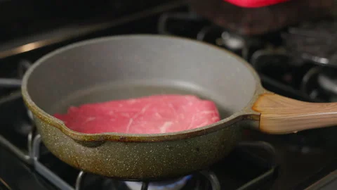 Cooking meat using a pan Stock Footage 318997334