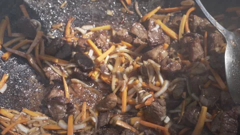 Cooking meat with vegetables in a cauldron Stock Footage 158679971