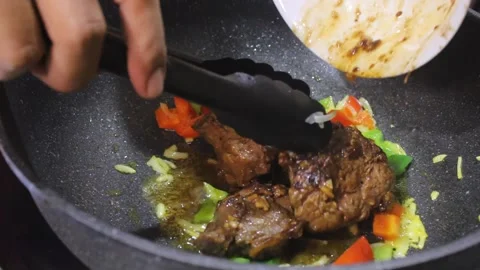Cooking meat with vegetables. Delicious stir-fried meat Stock Footage 334268355