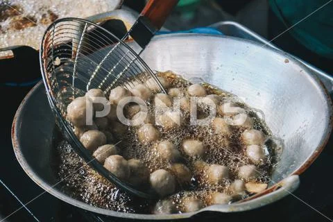 Cooking meatballs in the boiling oil in frying pan Stock Photos