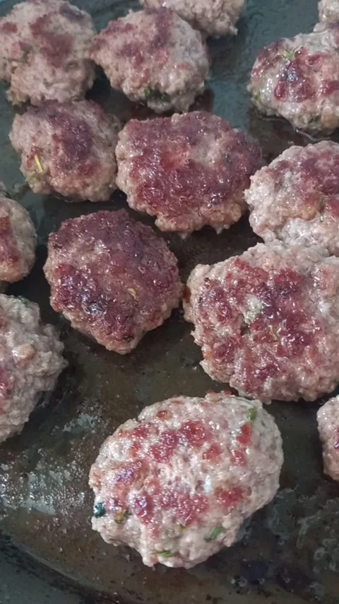 Cooking meatballs on a grill pan Stock Footage 274830901