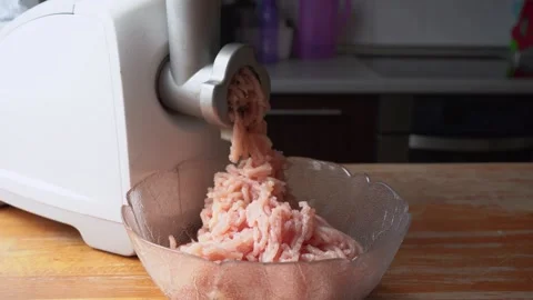 Cooking minced meat from fresh chicken breast for cutlets. Electric meat grinder Stock Footage 303892387