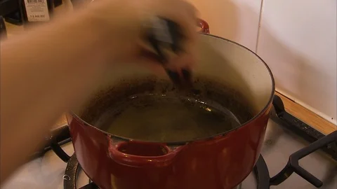 Cooking mixed vegetables in red casserole Stock Footage 88042497