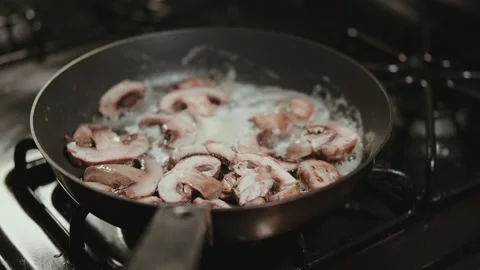 Cooking mushrooms in kitchen Video stock 304170374