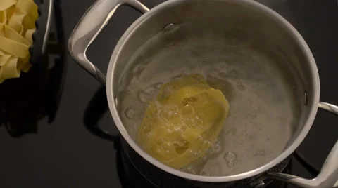 Cooking nest pasta in boiling water on electric stove Stock Footage 67989953