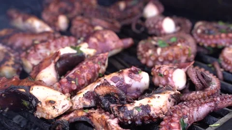Cooking octopus on a barbeque grill Stock Footage 151329342