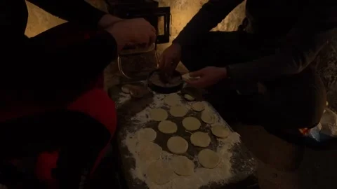 Cooking in an old hut. They make dumplings. Video stock 233206772