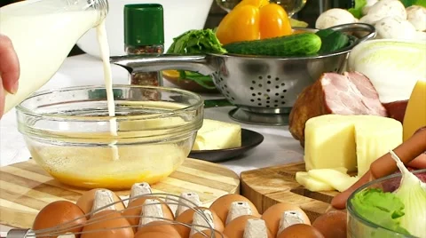 Cooking omelet. To add the beaten egg and milk mix blender Stock Footage 64570835