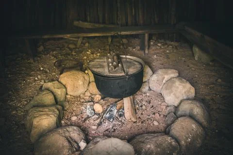 Cooking on an open fire. Old fire pit 库存照片