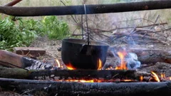 Traditional Cuisine Big Black Pot Cooking Food, Natural Fire With Wood  Heating Stock Photo, Picture and Royalty Free Image. Image 91055974.