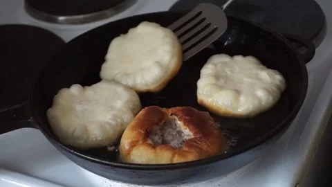 Cooking open pies with minced meat in oil on frying pan Stock Footage 166558041