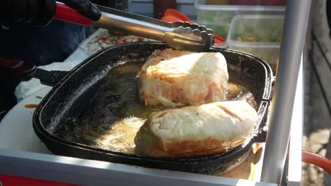 Cooking or frying beef spring rolls in a frying pan Stock Footage 309725577