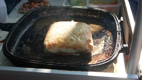 Cooking or frying beef spring rolls in a frying pan Stock Footage 309725921