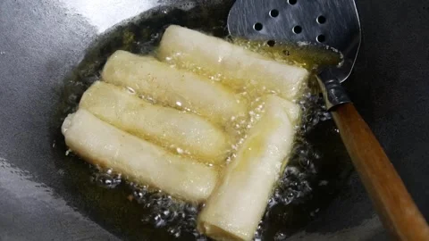 Cooking or frying risoles in a frying pan Stock Footage 304722211