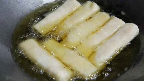 Cooking or frying risoles in a frying pan Stock Footage 304722221
