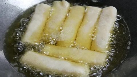 Cooking or frying risoles in a frying pan Stock Footage 304722223
