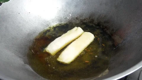 Cooking or frying risoles in a frying pan Stock Footage 304722233