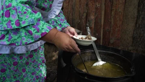 Cooking an oriental dish in a cauldron on fire Stock Footage 236910047
