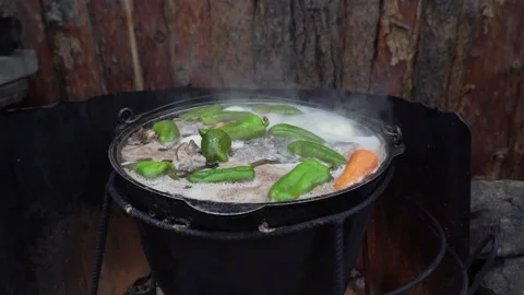 Cooking an oriental dish in a cauldron on fire Video stock 237100702